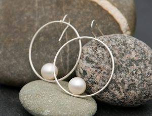 white pearl hoop earrings in silver
