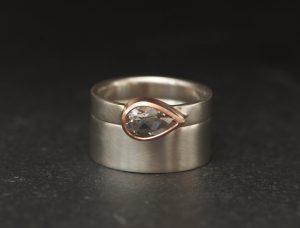White topaz wedding set featuring pear cut stone and silver rings