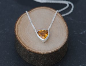 Simple Citrine trillion pendant in satin finished sterling silver. Available with 16″ or 18″ chain. Designed and handmade by William White in Cornwall, UK