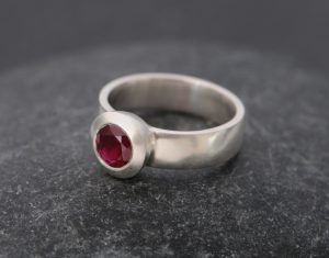 Ruby solitaire set in silver ring