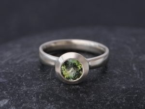 green tourmaline stone set in white gold ring