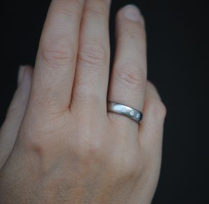 18K white gold band with 3 diamonds on hand