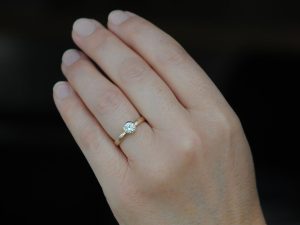 diamond-set-in-18K-rose-gold-ring-on-hand-3