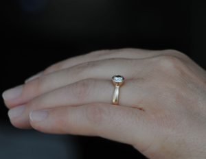diamond-set-in-18K-rose-gold-ring-on-hand-side-on