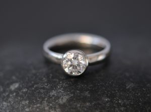 moissanite 6mm round bezel set in platinum