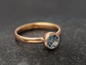 aquamarine AAAA 7mm bezel set in 18K r gold