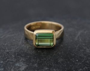 green tourmaline ring set in satin finished 18k yellow gold.