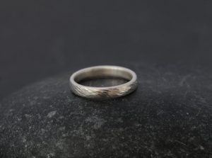 textured silver wedding band for her.