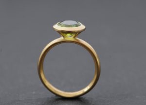 peridot 8mm halo ring in 18K y gold