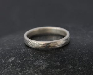 textured silver wedding band for her.