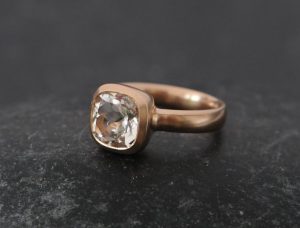 white topaz 8mm cushion in 18K r gold.