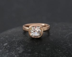 white topaz 8mm cushion in 18K r gold.