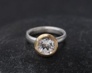 white topaz halo ring in 18K y gold and silver band
