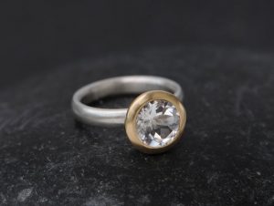 white topaz halo ring in 18K y gold and silver band