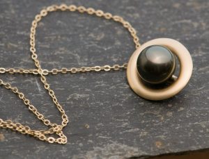 black pearl halo necklace in 9k gold