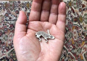 silver rabbit brooch with rubies and sapphire