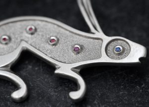 silver rabbit brooch with rubies and sapphire