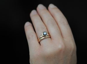 black diamond halo wedding set in 18K rose gold on hand