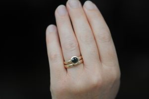 black diamond halo wedding set in 18K rose gold on hand