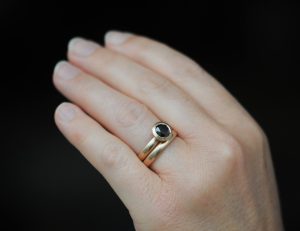 black diamond halo wedding set in 18K rose gold on hand