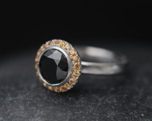 black-diamond-9mm-and-sapphire-halo-ring-in-platinum