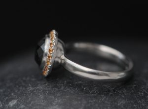 black-diamond-9mm-and-sapphire-halo-ring-in-platinum