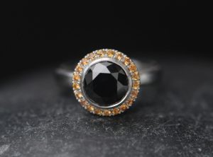 black-diamond-9mm-and-sapphire-halo-ring-in-platinum