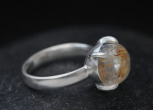 rutilated quartz 12mm cab dragons eye ring silver on hand