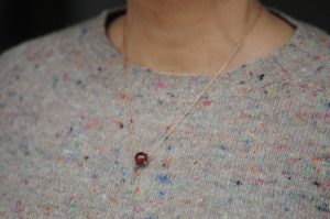 hessonite-garnet-10mm-cab-dragons-eye-necklace-in-18K-rose-gold-on-model