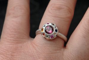 pink-tourmaline-button-ring-with-sapphires-in-silver-on-hand