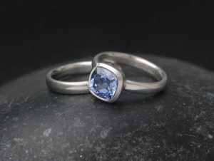 lab-sapphire-light-blue-8mm-cushion-cut-wedding-set-in-platinum-on-hand