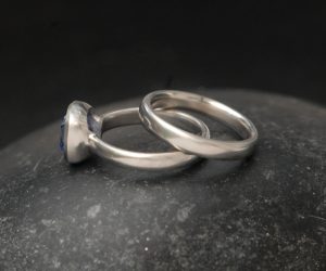 lab-sapphire-light-blue-8mm-cushion-cut-wedding-set-in-platinum-on-hand