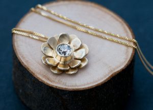 gold flower necklace with diamond flower centre
