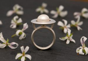 white pearl ring in silver with halo design