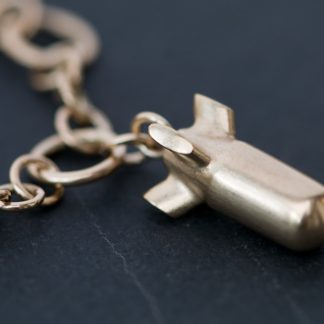 bomb charm on handmade gold chain bracelet