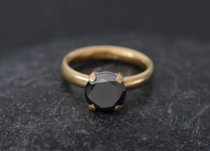 Black diamond engagement ring claw set in gold. By William White