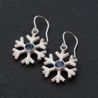 Charming Blue sapphire snowflake earrings, set in sterling silver. These delicate snowflakes are designed and handmade by William White in Cornwall, UK