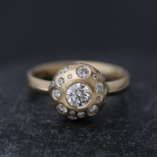White conflict free diamond set in 18k gold with 20 small diamonds surrounding it