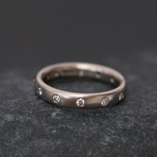 Diamond eternity ring in 18k gold. By William White