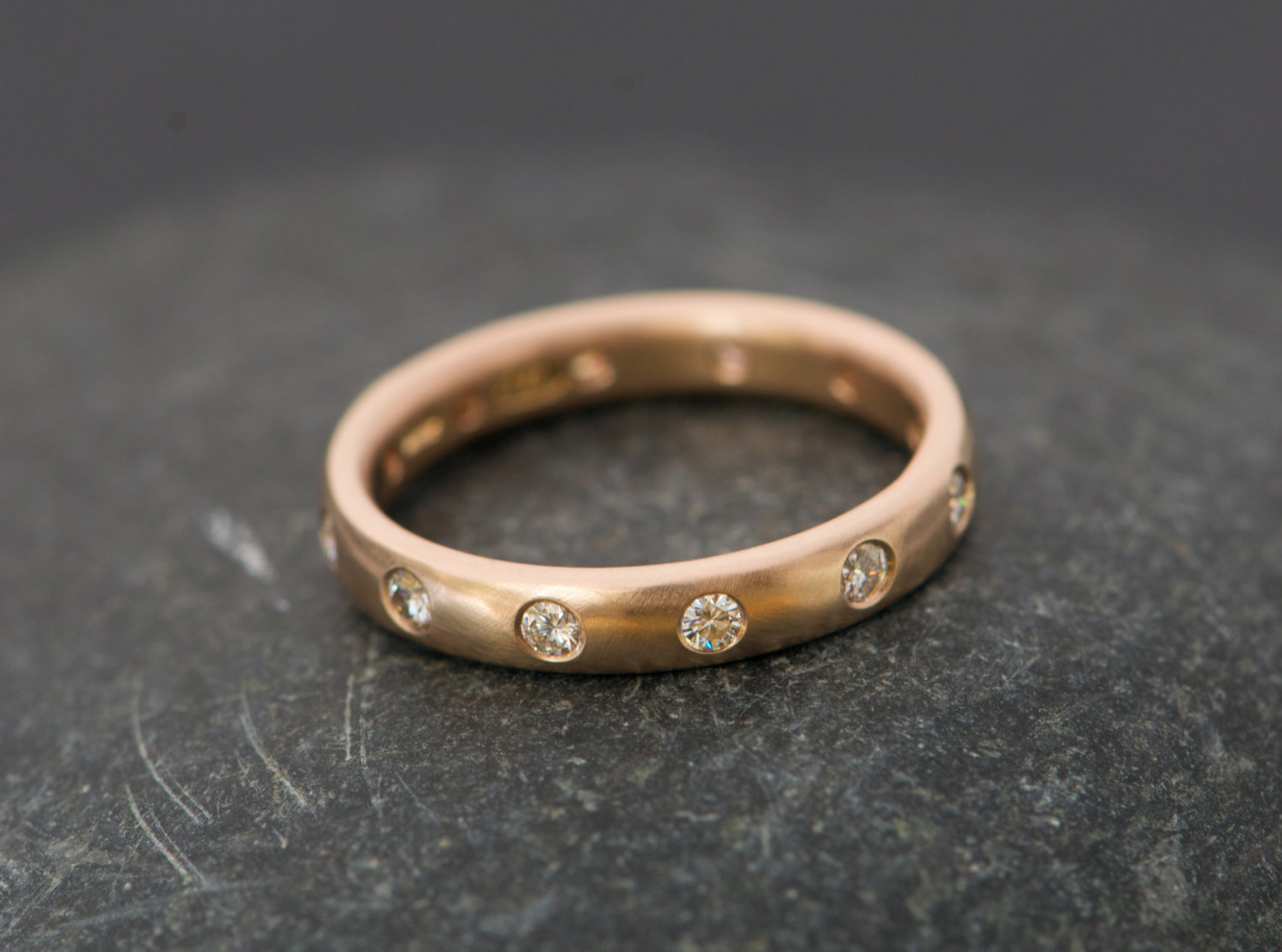 18k rose gold eternity ring set with moissanite stones