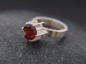 Deep red garnet fin ring in satin finished sterling silver. By William White