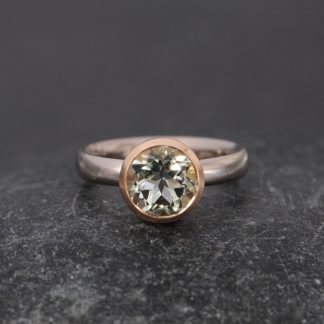 pale green amethyst set in yellow gold bezel on white gold ring