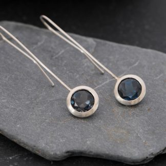 Deep blue, clean and simple London blue topaz 'lollipop' earrings, set in sterling silver. Adjustable length earrings designed and handmade by William White