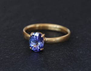 purple blue tanzanite solitaire set in gold ring