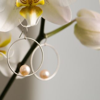 Peach pearl hoop earrings in silver. By William White