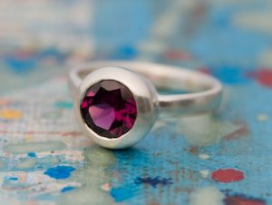 Beautiful deep pink Rhodolite Garnet, set in satin finished sterling silver. A lovely alternative engagement ring. By William White
