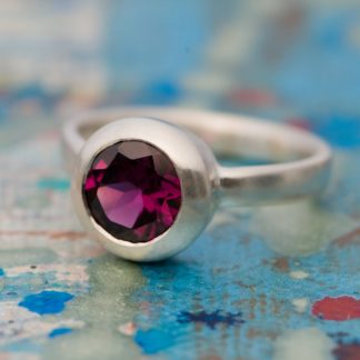 Beautiful deep pink Rhodolite Garnet, set in satin finished sterling silver. A lovely alternative engagement ring. By William White