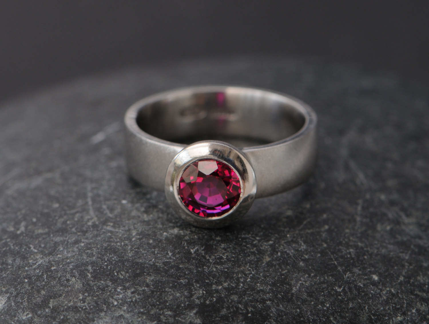 Synthetic ruby set in platinum ring.