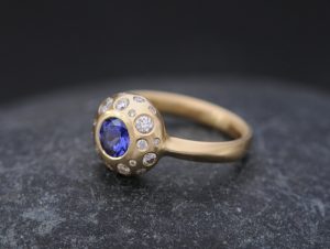 tanzanite and diamond cluster ring set in gold