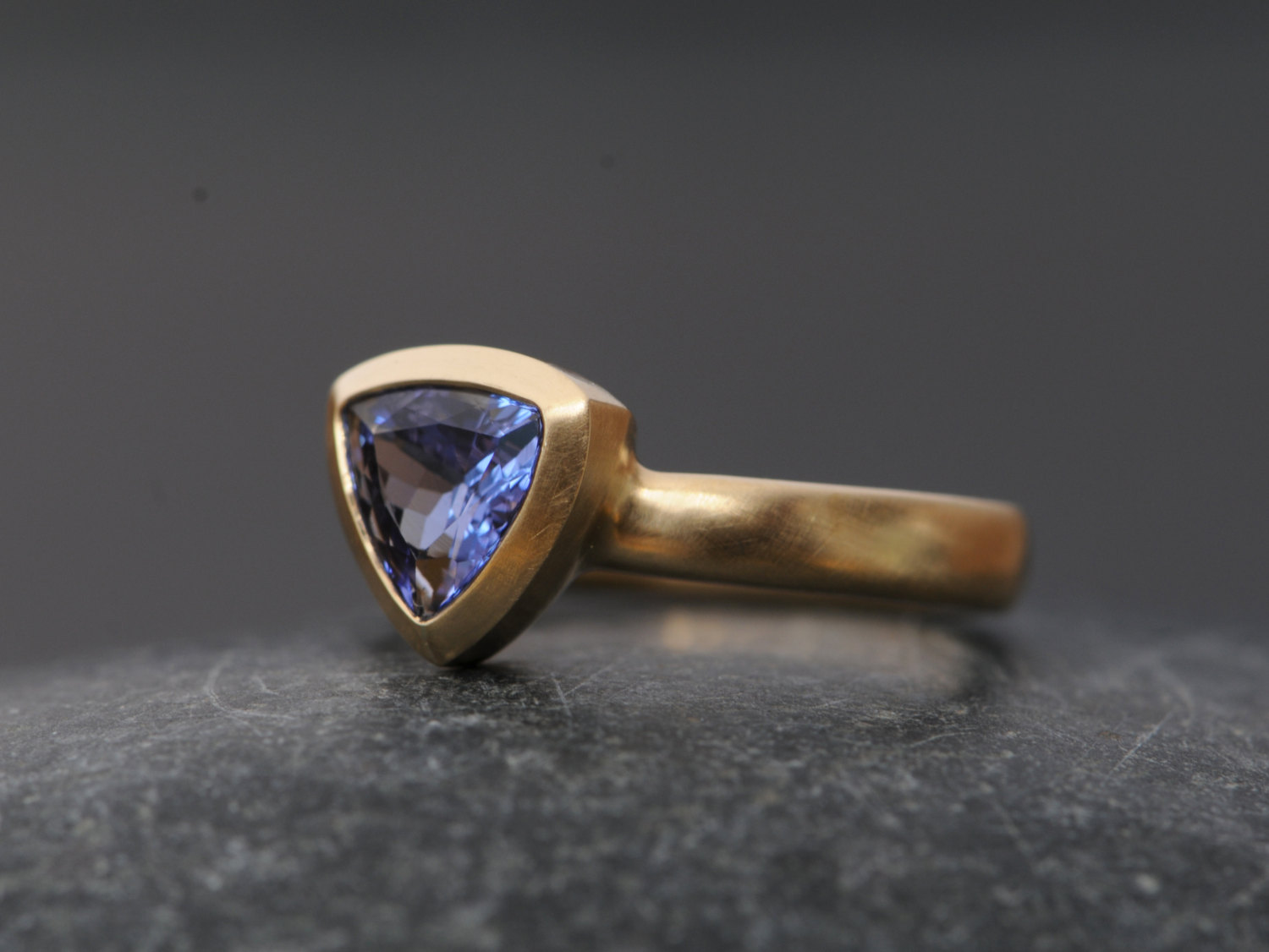 Purple blue trillion cut tanzanite set in 18k gold ring. By William White